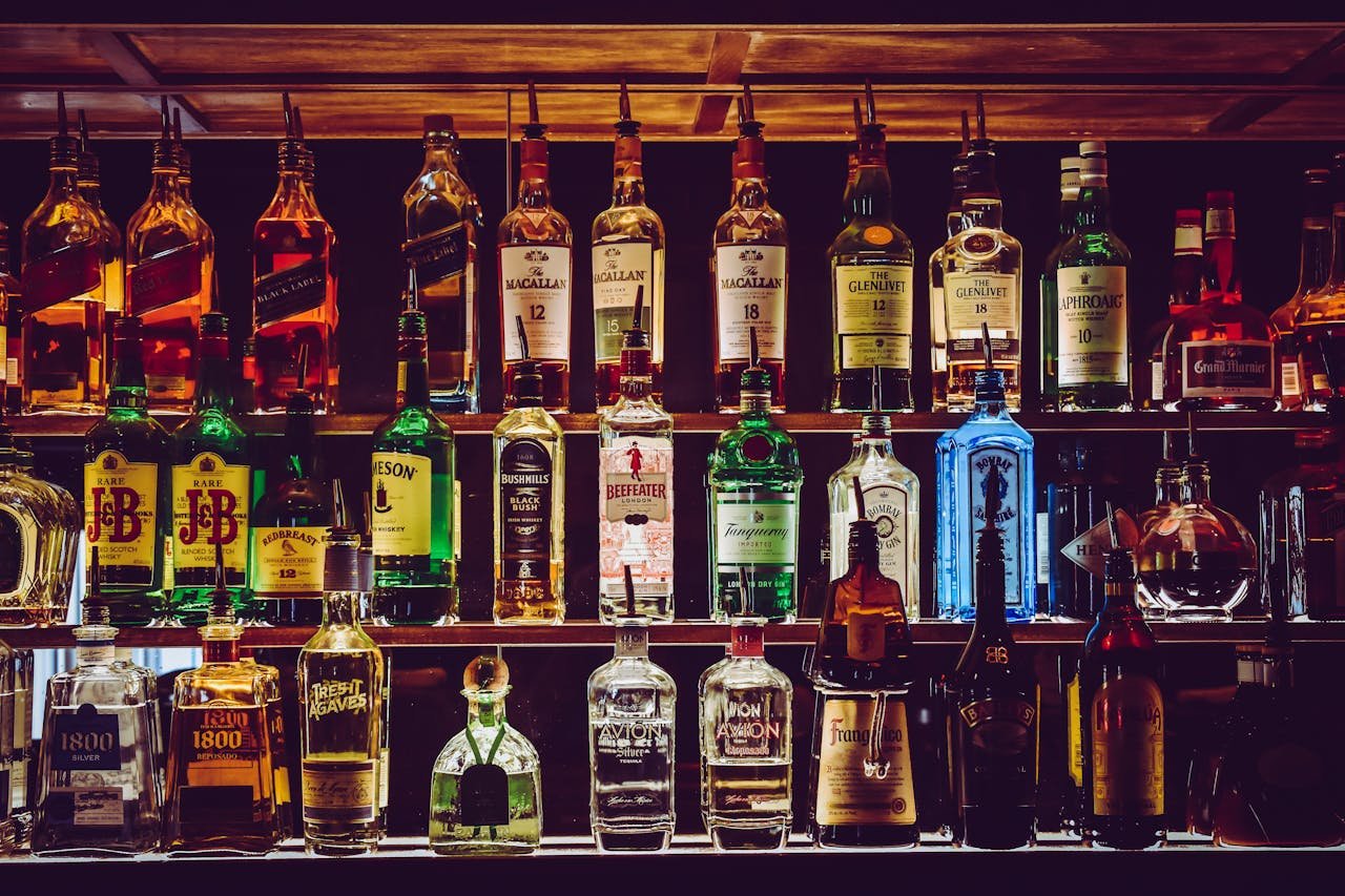 Bar Cafetería en Montanejos. An array of various liquor bottles beautifully displayed on a bar shelf.
