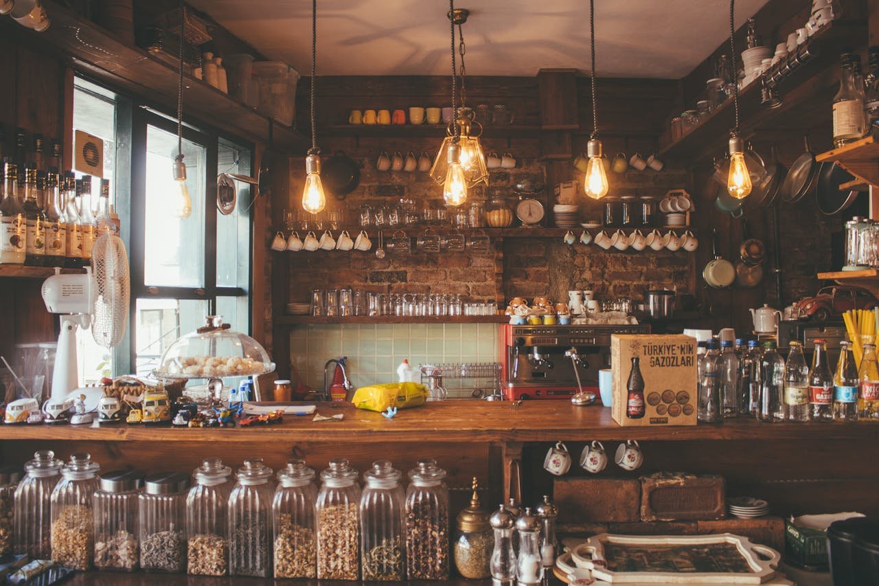 Servicios Bar Los Luises en Montanejos. A cozy cafe with rustic decor, pendant lights, and glass jars creates a vintage ambiance.